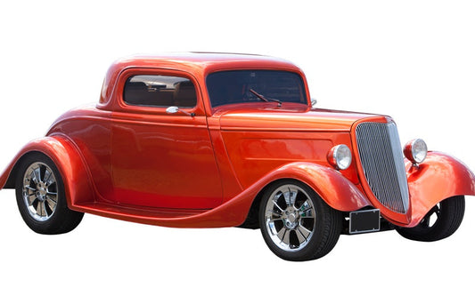 A red, two-door hot rod with a front grille, two round headlights, and chrome details, shown on a white background.